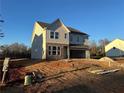 Two-story house with gray siding and stone accents at 7293 Eton Ln, Locust Grove, GA 30248