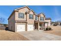 Two-story house with a three-car garage and partial brick exterior at 7705 Sylvaner Ln, Atlanta, GA 30349