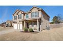 Two-story house with a three-car garage and landscaping at 7705 Sylvaner Ln, Atlanta, GA 30349