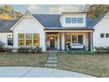 White farmhouse features a front porch and stone walkway at 201 Edwards Brook Ct, Canton, GA 30115