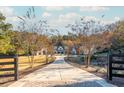 Long driveway to a stunning farmhouse with a large lawn at 201 Edwards Brook Ct, Canton, GA 30115