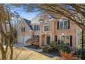 Two-story brick home with a large front yard and mature trees at 6820 Milbury Ct, Alpharetta, GA 30005