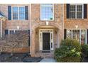 Elegant front entrance with a dark door and brick archway at 6820 Milbury Ct, Alpharetta, GA 30005