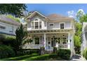 Two story home with wrap around porch and manicured landscaping at 34 Peachtree Ne Cir, Atlanta, GA 30309