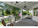 Spacious front porch with swing and hanging plants at 34 Peachtree Ne Cir, Atlanta, GA 30309