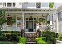 Charming front porch with stone steps and hanging plants at 34 Peachtree Ne Cir, Atlanta, GA 30309