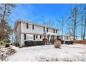 Two-story house with gray siding, red door, and snow on the ground at 4071 Williamsburg Dr, Atlanta, GA 30337