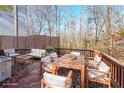 Spacious deck with wooden furniture, overlooking a wooded area at 1550 Park Creek Ne Ln, Brookhaven, GA 30319