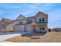 Two story brick home with three car garage and manicured lawn at 2771 Dolce Rd, Dacula, GA 30019