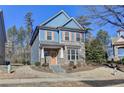 Two-story house with blue siding, brick accents, and a peach-colored door at 2329 Village Grove Dr, Suwanee, GA 30024