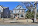 Two-story house with blue siding, brick accents, and a peach-colored door at 2329 Village Grove Dr, Suwanee, GA 30024