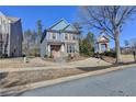 Two-story house with blue siding, brick accents, and a peach-colored door at 2329 Village Grove Dr, Suwanee, GA 30024