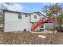 Home's back features a deck, stairs, and a spacious yard at 2649 Porter Dr, Lawrenceville, GA 30044