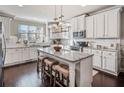 Spacious kitchen with white cabinets, granite island, and hardwood floors at 132 Marietta Walk Trce, Marietta, GA 30064