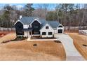 Two-story modern farmhouse with a large backyard and a three-car garage at 208 Pindos Sw Pl, Powder Springs, GA 30127