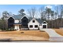 A modern farmhouse with white and black exterior and landscaping at 208 Pindos Sw Pl, Powder Springs, GA 30127