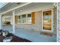 Covered porch with decorative columns and wood front door at 2833 Alan Sw Dr, Marietta, GA 30064