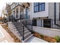 Attractive townhome exterior showing brick facade, black wrought iron railings, and a welcoming entrance at 530 Fisher Dr # 45, Alpharetta, GA 30009