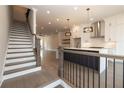 Modern staircase with dark wood railings overlooking a kitchen and living area at 530 Fisher Dr # 45, Alpharetta, GA 30009