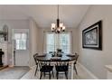 Charming dining room with a round table and six chairs, complemented by natural light at 770 Dunagan Forest Dr, Lawrenceville, GA 30045