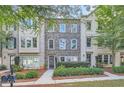 Three-story brick townhouses with lush landscaping at 9972 Ashton Old Rd, Douglasville, GA 30135