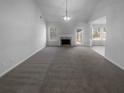 Spacious living room with gray carpeting and a fireplace at 220 Mountain Way, Covington, GA 30016