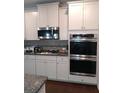Modern kitchen featuring stainless steel appliances and granite countertops at 780 Codex Dr, Fairburn, GA 30213