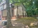 Side yard view of home with mature trees at 121 Creighton, Marietta, GA 30008