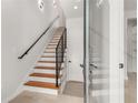 Modern staircase with built-in shelving and metal railing at 105 Georgia Se Ave # 1, Atlanta, GA 30312