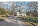 Front view of a white house with a carport and landscaping at 4106 Newman Ellis Rd, Douglasville, GA 30134