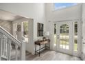 Bright entryway with hardwood floors, a console table, and access to the staircase at 118 Bellington Dr, Mcdonough, GA 30253