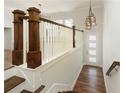 Elegant entryway featuring a wood staircase and modern lighting at 4382 Benfield Se Way, Smyrna, GA 30080