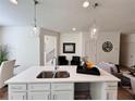 Kitchen island with white quartz countertop and a double sink at 1822 Emory Ln # 89, Conyers, GA 30013