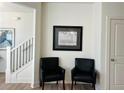 Cozy sitting area with two black armchairs near the staircase at 1822 Emory Ln # 89, Conyers, GA 30013