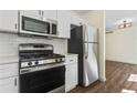 Modern kitchen featuring stainless steel appliances and white shaker cabinets at 456 Pine Shadows Dr, Dallas, GA 30157