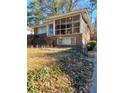 Charming brick home with a screened porch and steps leading to the entrance at 141 Holly Nw Rd, Atlanta, GA 30314