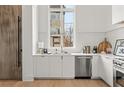 Modern white kitchen with stainless steel appliances and large window at 145 Arcadia Ave, Fayetteville, GA 30214