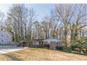 Brick ranch house with carport and mature trees at 3390 Kenland Se Rd, Smyrna, GA 30082