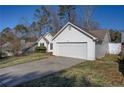 White sided home with a two car garage and driveway at 540 Saddle Shoals Dr, Lawrenceville, GA 30046