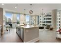 Modern kitchen with island, stainless steel appliances, and city views at 1080 Peachtree Ne St # 1402, Atlanta, GA 30309