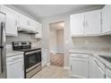 Kitchen with white cabinets, granite countertops, and stainless steel appliances at 3530 Kingsbrooke Ct, Decatur, GA 30034