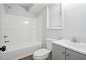 Updated bathroom with gray vanity, white tub and shower at 5879 Wellborn Trl, Lithonia, GA 30058