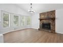 Living room features a stone fireplace and wood-look flooring at 5879 Wellborn Trl, Lithonia, GA 30058