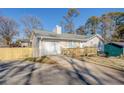 Front view of house with driveway and new fence at 912 Northridge Nw Dr, Conyers, GA 30012