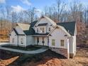Two story farmhouse with white siding, stone accents, and a covered porch at 221 Heritage Town Pkwy, Canton, GA 30115