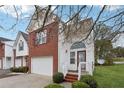 Two-story brick townhouse with a white front door at 6235 Queen Meadow Se Dr, Mableton, GA 30126