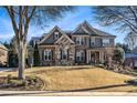 Two-story house with stone and brick accents, and a spacious lawn at 2082 Greenway Mill Ct, Snellville, GA 30078