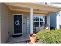 Inviting front porch with rocking chairs and a welcome sign at 311 Tuggle Ct, Woodstock, GA 30188