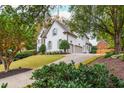 Two-story home with a side view of the garage at 3214 Burnette Ne Dr, Roswell, GA 30075