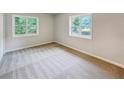 Bright bedroom with neutral carpeting and large windows at 170 Pinehurst Dr, Stockbridge, GA 30281